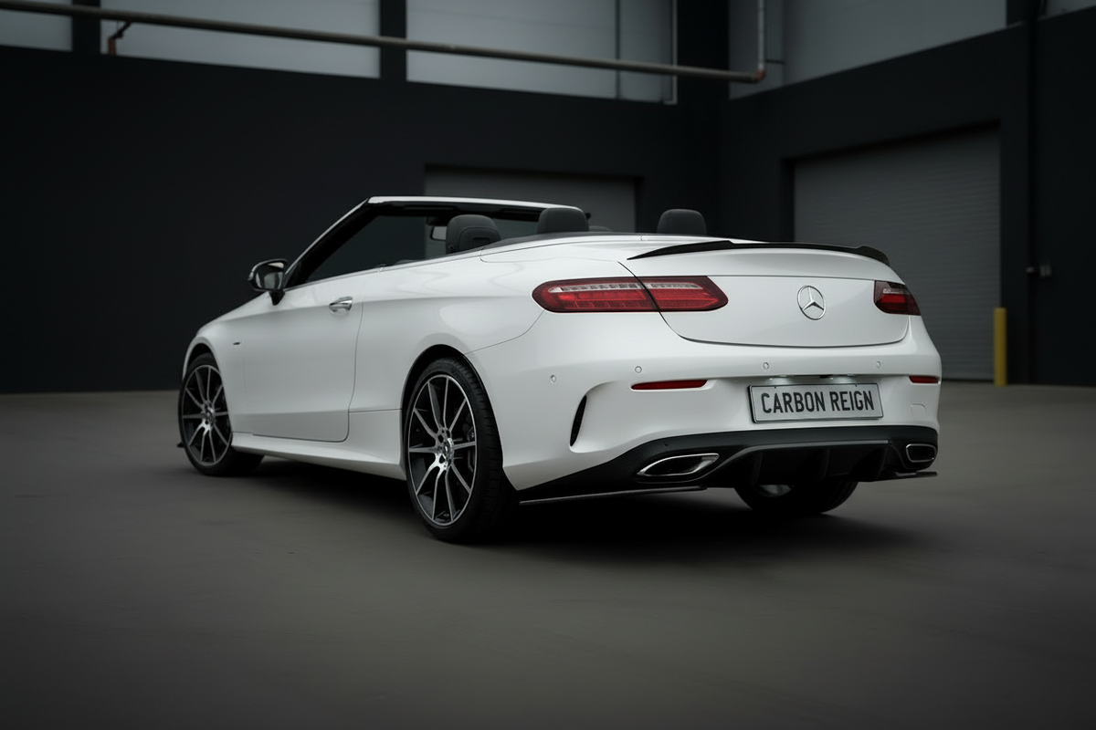 A white Mercedes-Benz Carbon Reign convertible is photographed from a rear three-quarter angle in a dark, modern garage or studio setting.