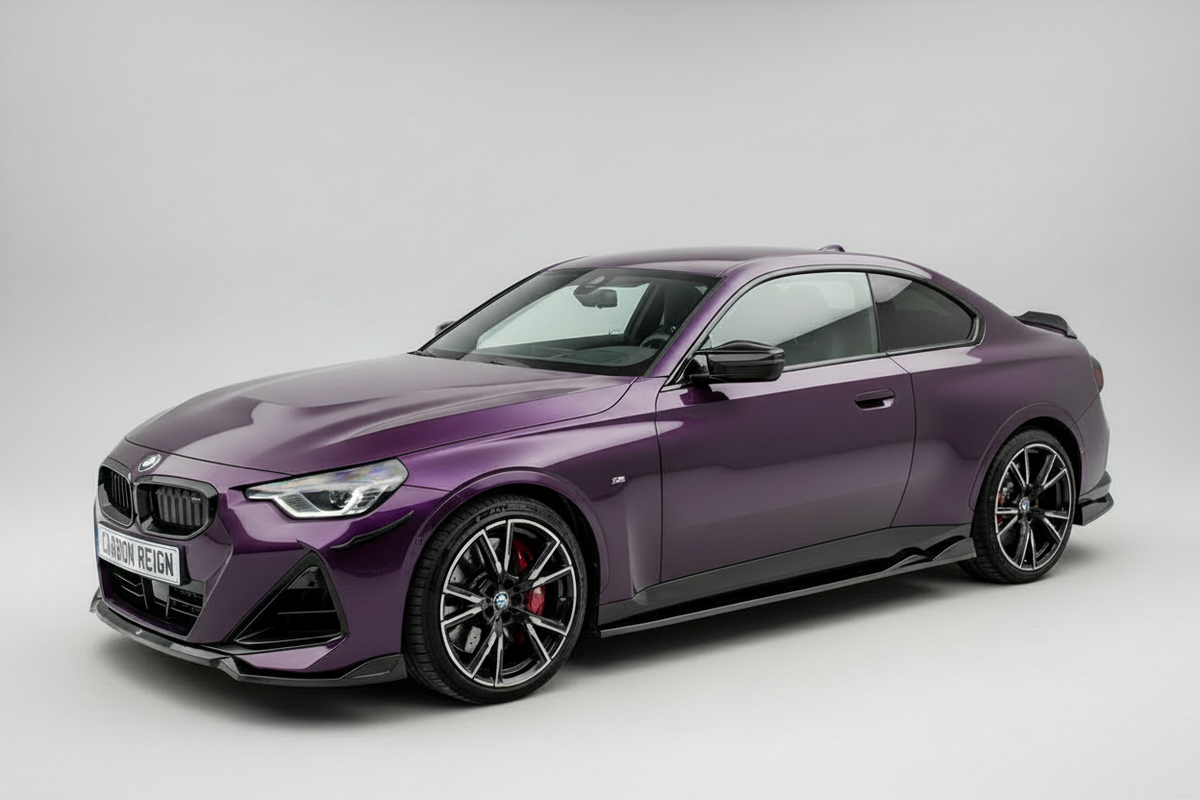 A purple BMW 2 Series coupe with black multi-spoke wheels and red brake calipers, photographed on a seamless light gray studio background.
