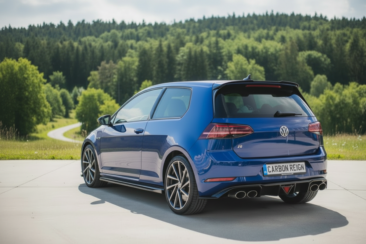 A blue Volkswagen Golf R with a carbon-reignered rear diffuser and quad exhaust, photographed from a rear three-quarter angle on a paved road with a lush green forest in the background.