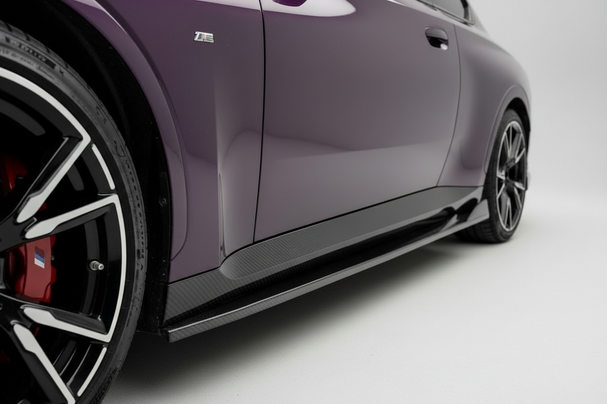 Close-up side view of a purple sports car showing the side skirt, carbon fiber trim, wheel, and red brake caliper against a clean white studio background.