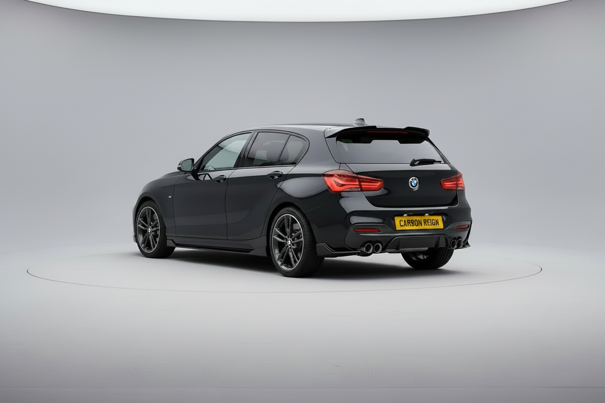 A dark gray BMW 1 Series hatchback is photographed from the rear three-quarter angle on a circular studio platform with a light gray backdrop.