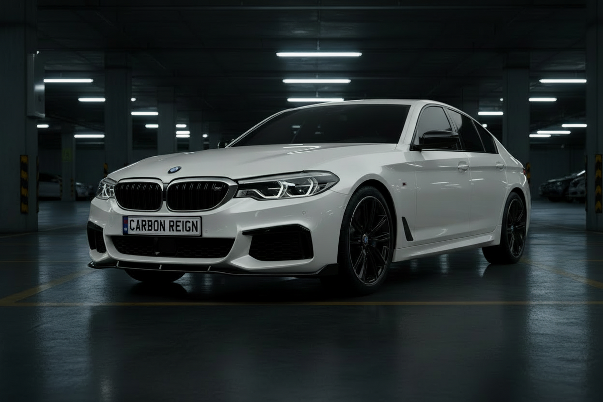 A white BMW sedan photographed in a dimly lit underground parking structure. The car is shown at a three-quarter front angle, featuring black wheels, a black kidney grille, and sleek headlights.